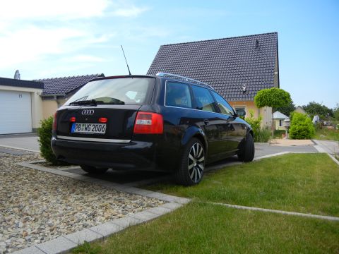 2003 Audi A6 - This black Audi wagon, identified by its license plate, is parked in a residential driveway.