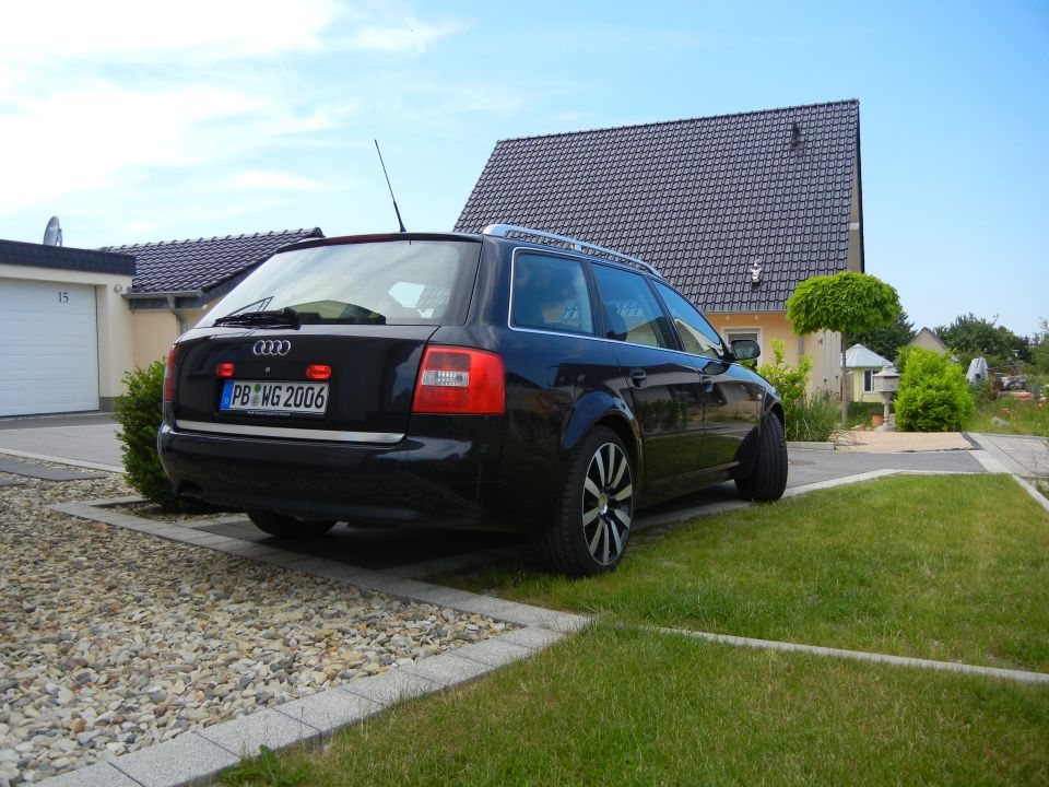 Black Audi wagon with license plate PB WG 2006 parked in a driveway