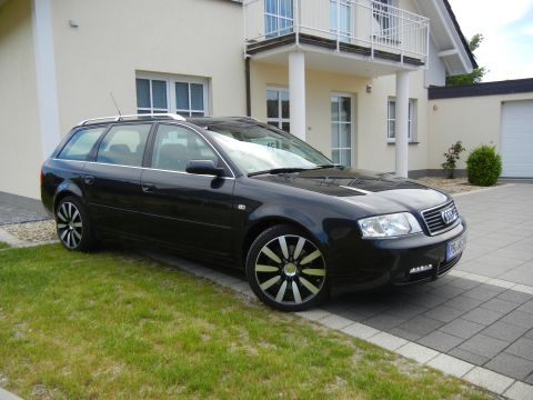 2003 Audi A6 - This black 2003 Audi A6 Avant is parked in front of a modern house.
