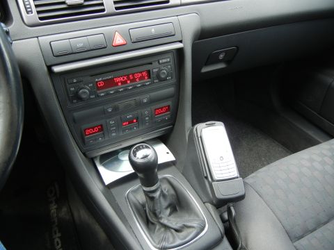 2003 Audi A6 - The interior of a car features a center console with a manual gear shifter and an Audi Concert CD player.