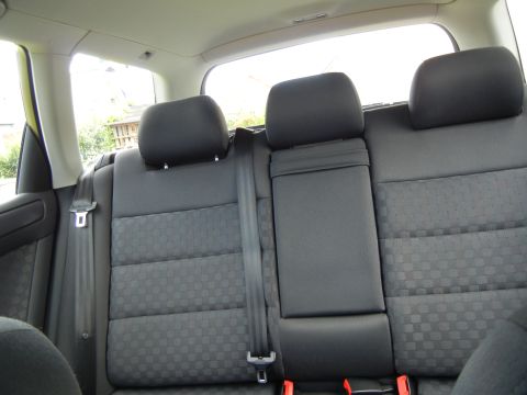 2003 Audi A6 - Interior view of the rear seats and seatbelts in a vehicle.
