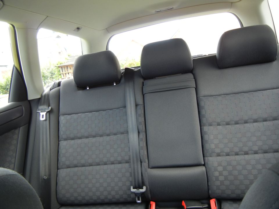 Black fabric rear seats with headrests and seatbelts. A watermark reads SUPERMOTORS