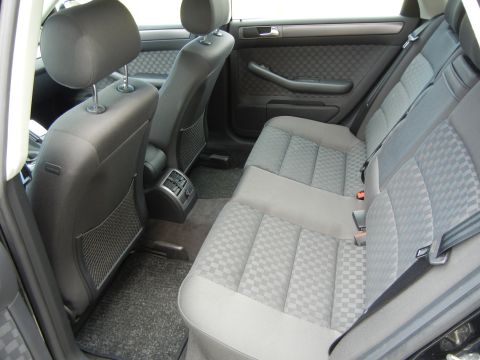 2003 Audi A6 - The rear interior of a car, showing the seats and door panel with a distinctive checkered fabric pattern.