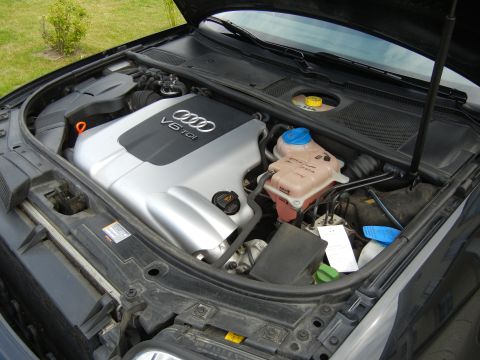 2003 Audi A6 - Engine bay of a dark-colored Audi, showing the V6 TDI engine and associated components.
