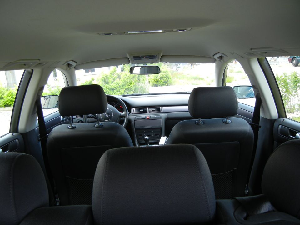 Interior view of a 2003 Audi A6, showing front seats, dashboard, and steering wheel