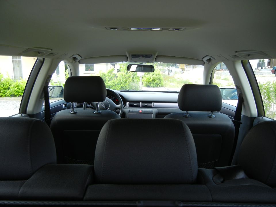 Interior view of a 2003 Audi A6 showing front seats, dashboard, and steering wheel