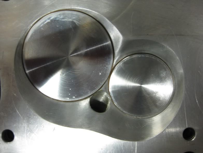 this is the 40.5cc shallow chamber. dropping the chamber lower into the cylinder, creates a longer intake port but at the stock location, instead of raising the port at the intake flange to improve the short turn radius