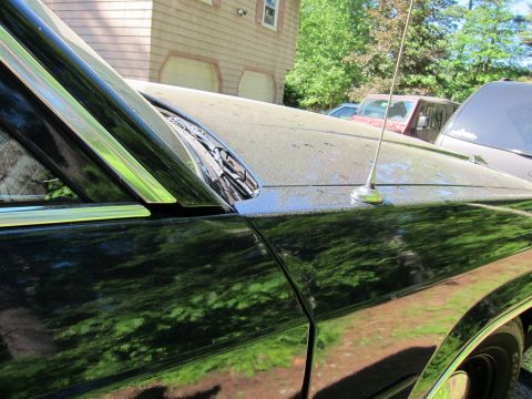 1991 Ford LTD Crown Victoria - A black sedan is parked outside a house with trees and another vehicle in the background.