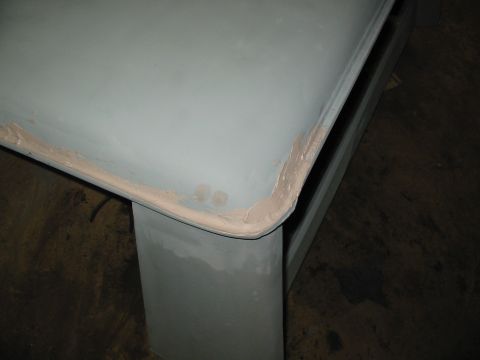 1969 Ford Bronco - A close-up of a car roof panel shows body filler along the edge, indicating repair work.
