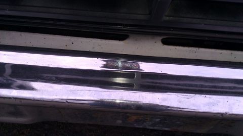 1984 Ford Bronco - Close-up of the front grille and chrome bumper of a 1984 Ford Bronco.