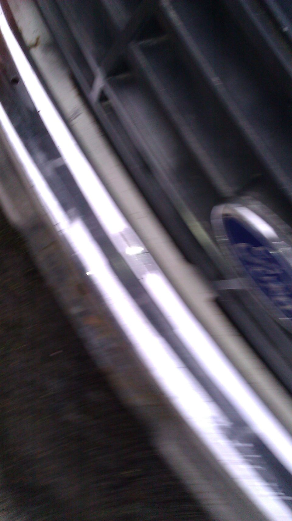 Close-up of a blue Ford emblem on a chrome-accented grille