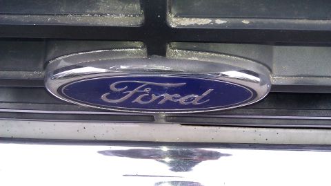 1984 Ford Bronco - Close-up of a Ford emblem on a vehicle's front grille, suggesting a model from the early 1980s.