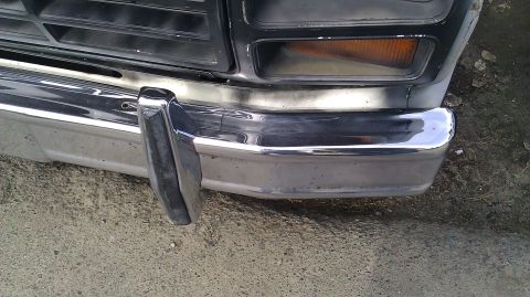 1984 Ford Bronco - Close-up of a chrome bumper and grille on an older model truck.