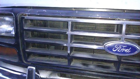 1984 Ford Bronco - Close-up of the front grille and Ford emblem on a Bronco, likely from the early 1980s.