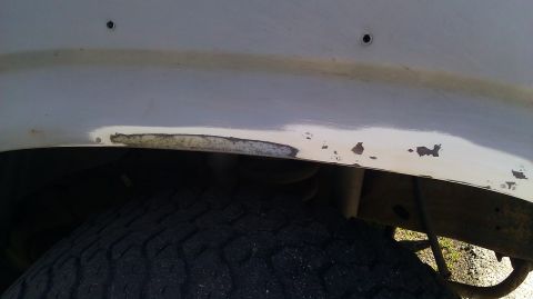 1984 Ford Bronco - Rust is visible on the fender of a vehicle, indicating potential body damage.