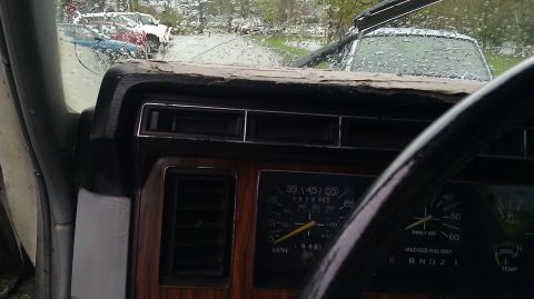 1984 Ford Bronco - Interior view of a 1984 Ford Bronco's dashboard, showing the instrument cluster and steering wheel.
