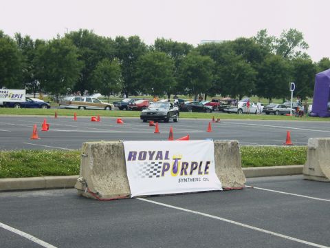 2007 Ford Mustang - A black sports car navigates a course marked by orange cones, with a Royal Purple banner visible.