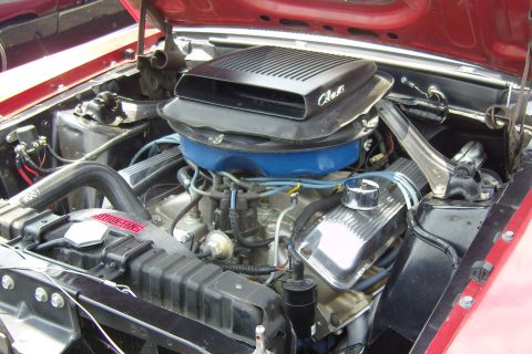 2007 Ford Mustang - Close-up of a V8 engine bay with a distinctive Cobra air intake scoop and chrome valve covers.