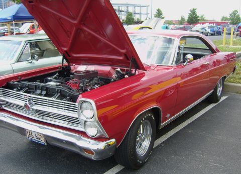 2007 Ford Mustang - A red 1966 Ford Fairlane coupe is parked with its hood up, revealing the engine compartment.