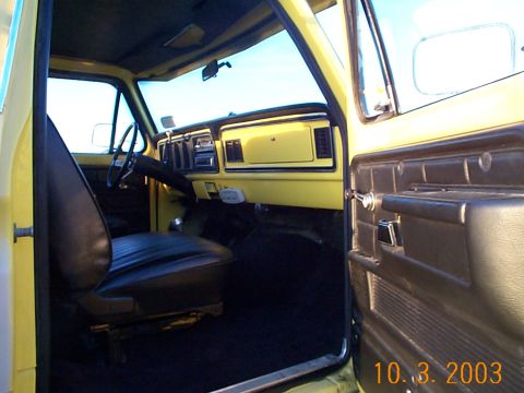 1978 Ford Bronco - Interior view of a yellow 1978 Ford Bronco, highlighting the driver's seat and dashboard details.