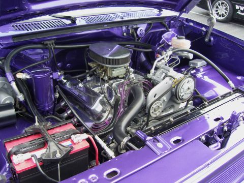 2007 Ford Mustang - Close-up view of a custom purple engine bay with a polished V8 engine and various components.