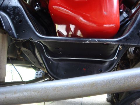 1989 Ford Bronco - Close-up view of the vehicle's chassis and engine components, showing the underside.