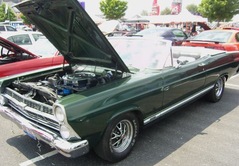 2007 Ford Mustang - Green 1967 Ford Fairlane convertible at an outdoor car show, hood raised to display the engine.