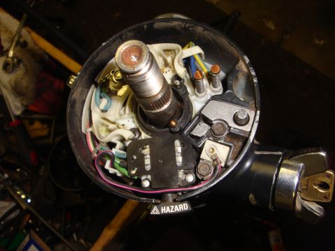 1989 Ford Bronco - Close-up view of a vehicle's steering column interior, showing electrical components and a key in the ignition.