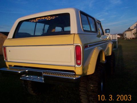 1978 Ford Bronco - This 1978 Ford Bronco is shown from the rear quarter angle, a two-tone yellow and white paint scheme and a chrome bumper.