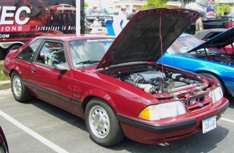 2007 Ford Mustang - A red 1987 Ford Mustang GT is parked with its hood open, revealing the engine bay.