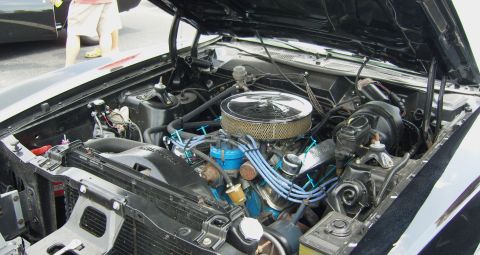 2007 Ford Mustang - The engine bay of a classic car, likely from the 1970s, is open for viewing.