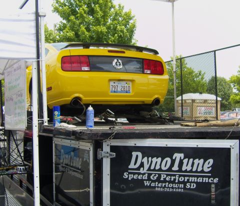 2007 Ford Mustang - A yellow Ford Mustang is positioned on a trailer for a dyno tune.