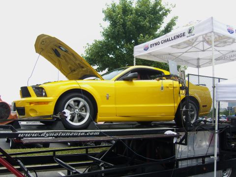 2007 Ford Mustang - A yellow 2007 Ford Mustang is positioned on a dynamometer for a dyno challenge event.
