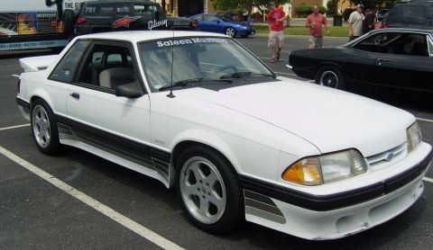 2007 Ford Mustang - White Saleen Mustang coupe with distinctive side graphics and a rear spoiler.