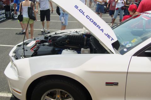 2007 Ford Mustang - White 2007 Ford Mustang's hood is open, revealing the 5.0L Cobra Jet engine.