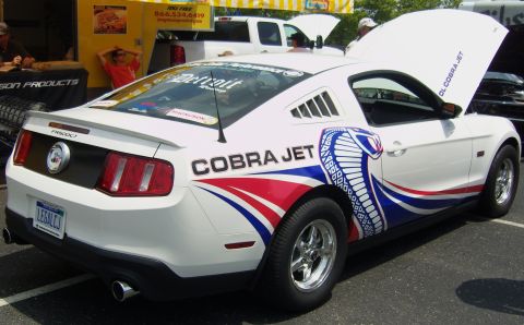 2007 Ford Mustang - White Ford Mustang with Cobra Jet graphics and racing slicks is displayed with its hood open.