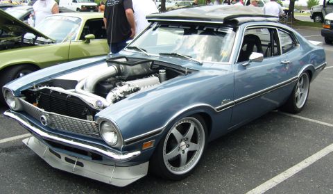 2007 Ford Mustang - A blue 1970 Ford Maverick is displayed with its hood open, revealing a custom engine build.