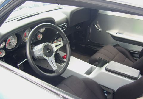 2007 Ford Mustang - Interior view of a modified car, custom gauges and racing seats.