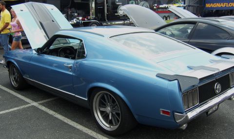 2007 Ford Mustang - A blue 1969 Ford Mustang Fastback is displayed with its hood open at an outdoor event.