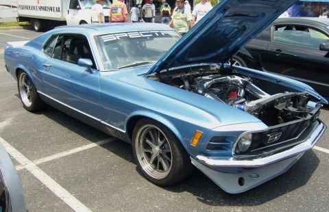 2007 Ford Mustang - A light blue classic Ford Mustang is displayed with its hood open, revealing the engine and a 'SPECTRE' banner across the windshield.