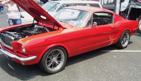 2007 Ford Mustang - Classic red Ford Mustang coupe on display, hood raised to reveal the engine bay.