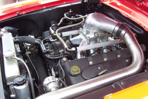 2007 Ford Mustang - Close-up of a modified V8 engine bay, likely from a Ford Mustang, with custom intake and turbo components.