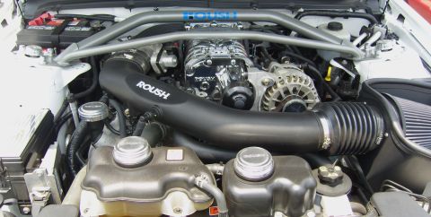 2007 Ford Mustang - The engine bay features a Roush supercharger and intake system, indicating performance modifications.