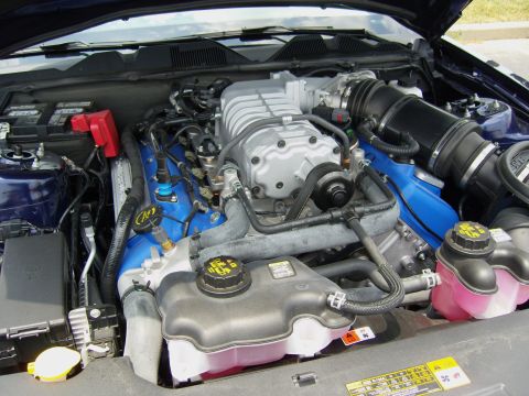 2007 Ford Mustang - Engine bay view of a supercharged V8 motor, likely from a performance vehicle.