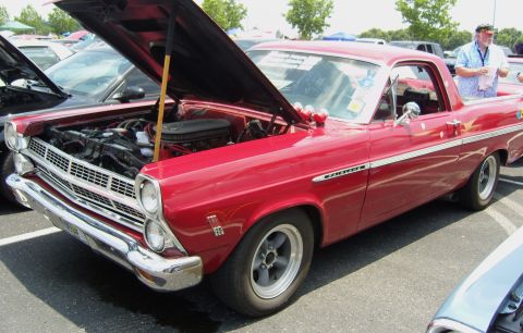 2007 Ford Mustang - A red 1966 Ford Fairlane 500 is parked with its hood open, revealing the engine bay.