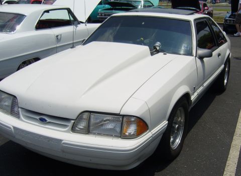2007 Ford Mustang - This Fox Body Mustang features a prominent hood scoop and custom wheels.