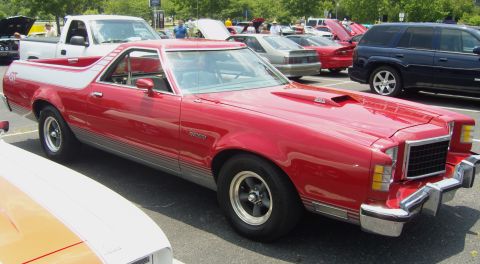 2007 Ford Mustang - A red 1977 Ford Ranchero GT is parked at an outdoor event, with other vehicles visible in the background.
