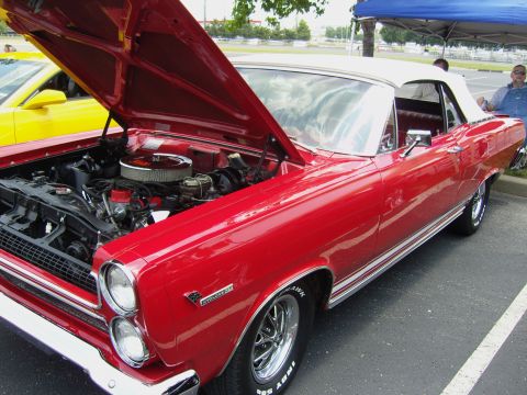 2007 Ford Mustang - A red 1967 Mercury Cougar convertible is displayed with its hood open, revealing the engine. The car has Indy 500 tires.