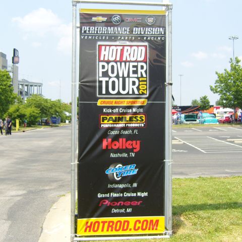 2007 Ford Mustang - Photograph of a Hot Rod Power Tour 2011 sponsor banner standing in a parking lot.