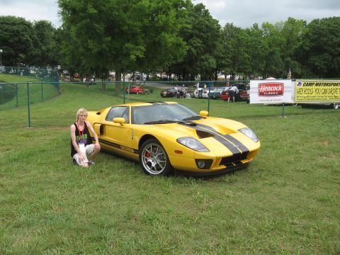 1968 Shelby GT500 - A yellow Ford GT with black racing stripes is displayed at an outdoor event.